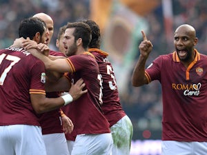 Roma defender Mehdi Menadia celebrates with teammates after scoring during the Italian Serie A football match As Roma vs Catania on December 22, 2013