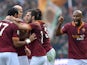 Roma defender Mehdi Menadia celebrates with teammates after scoring during the Italian Serie A football match As Roma vs Catania on December 22, 2013