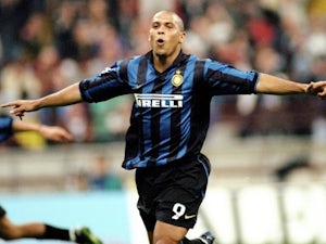 Brazilian striker Ronaldo poses with his AC Milan jersey on