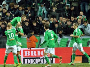 St Etienne's French forward Mevlut Erding is congratulated by his teammates after scoring during the French L1 football match Saint-Etienne (ASSE) vs Nantes (FCNA) on December 21, 2013