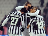 Sebastian Giovinco of Juventus celebrates with team-mates after scoring the opening goal with team-mate during the Tim Cup match against US Avellino on December 18, 2013