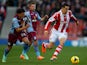Aleksander Tonev of Aston Villa competes for the ball with Geoff Cameron of Stoke during the Barclays Premier League match between Stoke City and Aston Villa at the Britannia Stadium on December 21, 2013