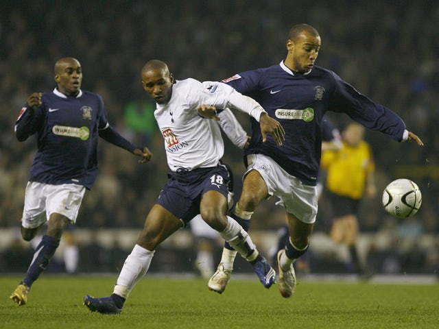 Jermain Defoe of Tottenham Hotspur tussles with Lewis Hunt of Southend United during the Carling Cup Quarter Final match between Tottenham Hotspur and Southend United at White Hart Lane on December 20, 2006 