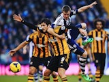 Danny Graham of Hull City and Alex Bruce of Hull City challenge for the ball during the Barclays Premier League match between West Bromwich Albion and Hull City at The Hawthorns on December 21, 2013 