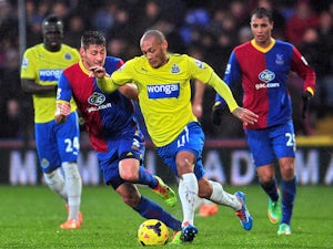 Newcastle United's French striker Yoan Gouffran vies for the ball with Crystal Palace's English defender Joel Ward during the English Premier League game on December 21, 2013