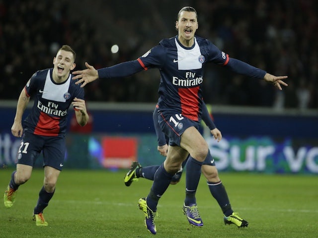Paris Saint-Germain's Swedish forward Zlatan Ibrahimovic (R) celebrates after scoring a goal during the French L1 football match between Paris Saint-Germain (PSG) and Lille on December 22, 2013