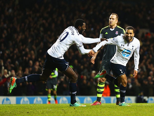 Tottenham's Aaron Lennon is congratulated by teammate Emmanuel Adebayor after scoring his team's third goal against Stoke during their Premier League match on December 29, 2013