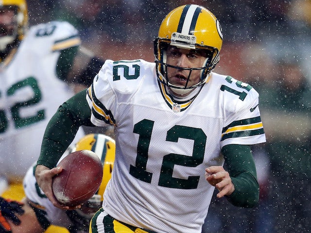 Quarterback Aaron Rodgers of the Green Bay Packers runs with the ball against the Chicago Bears during a game at Soldier Field on December 29, 2013 