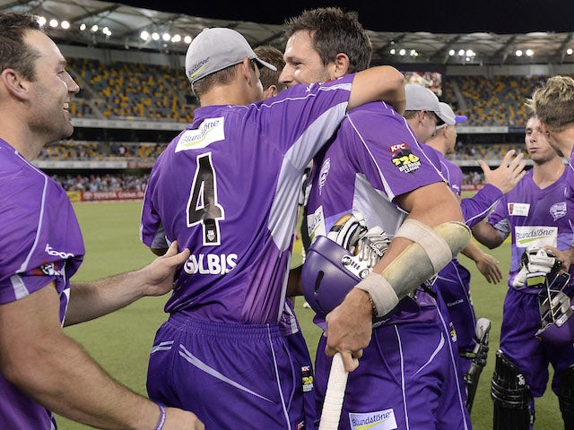 Ben Hilfenhaus of the Hurricanes celebrates victory with team mates during the Big Bash League match between Brisbane Heat and the Hobart Hurricanes on December 28, 2013