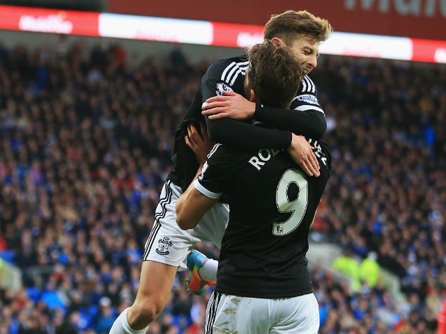 Jay Rodriguez of Southampton is congratulated by Adam Lallana after his opening goal during the Barclays Premier League match between Cardiff City and Southampton at Cardiff City Stadium on December 26, 2013 