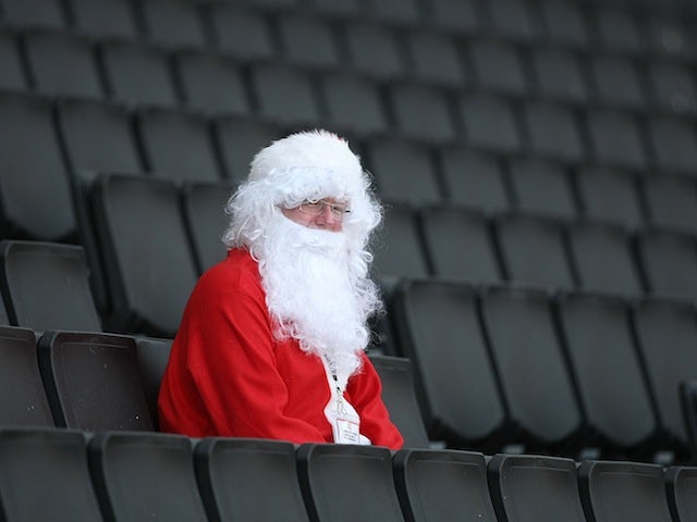 A lonely football fan sits in his Santa Claus costume at Stadium MK on October 15, 2011