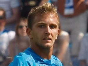 Domenico Criscito of FC Zenit St. Petersburg scores as Anton Shunin of FC Dynamo Moscow defends during the Russian Football League Championship match on July 22, 2013
