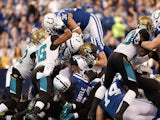 Donald Brown of the Indianapolis Colts dives over the pile of Jacksonville Jaguars defenders for a fist quarter touchdown at Lucas Oil Stadium on December 29, 2013