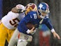  Quarterback Eli Manning of the New York Giants is sacked by inside linebacker Perry Riley #56 of the Washington Redskins on December 29, 2013