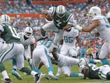 Geno Smith of the New York Jets dives for the end zone but is stopped short by the Miami Dolphins defense during second quarter action on December 29, 2013