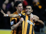 George Boyd of Hull City congratulates team-mate Ahmed Elmohamady after scoring a goal during the Barclays Premier League match between Hull City and Fulham on December 28, 2013