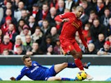 Glen Johnson of Liverpool is tackled by Craig Noone of Cardiff City during the Barclays Premier League match between Liverpool and Cardiff City at Anfield on December 21, 2013