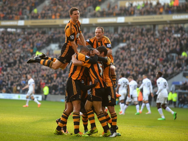 James Chester of Hull Cityis mobbed after scoring the opening goal during the Barclays Premier League match between Hull City and Manchester United at KC Stadium on December 26, 2013