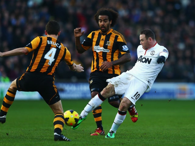 Wayne Rooney of Manchester United shoots and scores his sides second goal during the Barclays Premier League match between Hull City and Manchester United at KC Stadium on December 26, 2013