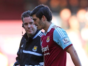 James Tomkins of West Ham leaves the field of play with an injury during the Barclays Premier League match against West Brom on December 28, 2013