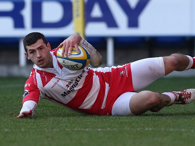 Gloucester's Jonny May dives over to score a try against London Irish during their Aviva Premiership match on December 29, 2013