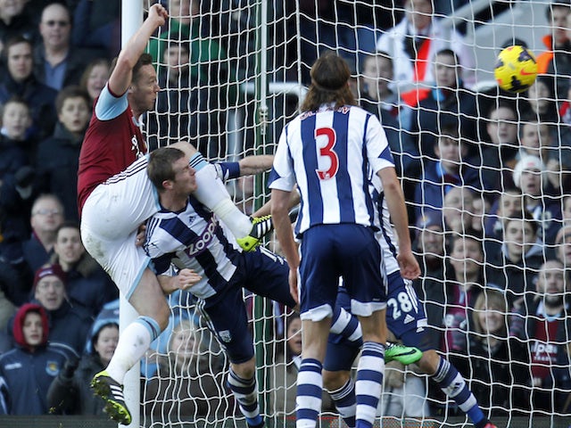 West Ham United's English midfielder Kevin Nolan scores their third goal against West Bromwich Albion on December 28, 2013