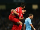 Luis Suarez of Liverpool congratulates goalscorer Philippe Coutinho during the Barclays Premier League match between Manchester City and Liverpool at Etihad Stadium on December 26, 2013