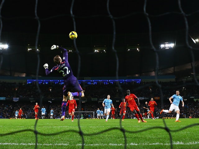 Alvaro Negredo of Manchester City shoots to score past Simon Mignolet of Liverpool during the Barclays Premier League match between Manchester City and Liverpool at Etihad Stadium on December 26, 2013