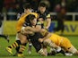 Mark Wilson of Newcastle is tackled by Carlo Festuccia and Sam Jones during the Aviva Premiership match between Newcastle Falcons and London Wasps at Kingston Park on December 27, 2013 