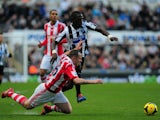 Newcastle player Moussa Sissoko tangles with Charlie Adam during the Barclays Premier League match between Newcastle United and Stoke City at St James' Park on December 26, 2013