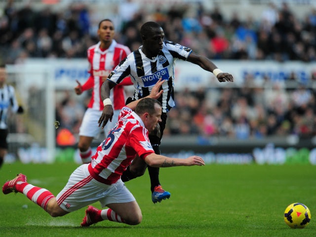 Newcastle player Moussa Sissoko tangles with Charlie Adam during the Barclays Premier League match between Newcastle United and Stoke City at St James' Park on December 26, 2013