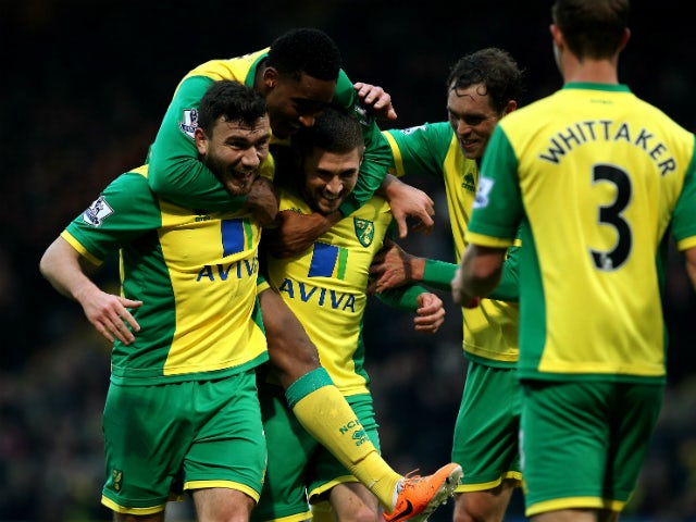 Norwich's Gary Hooper celebrates scoring the first goal of the game with team mates Robert Snodgrass, Leroy Fer and Johan Elmander during the Barclays Premier League match between Norwich City and Fulham at Carrow Road on December 26, 2013