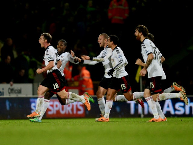 Scott Parker of Fulham celebrates with team mates as he scores their second goal during the Barclays Premier League match between Norwich City and Fulham at Carrow Road on December 26, 2013