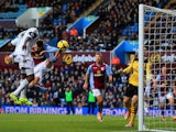 Roland Lamah of Swansea City heads in their first goal past Brad Guzan of Aston Villa during the Barclays Premier League match on December 28, 2013