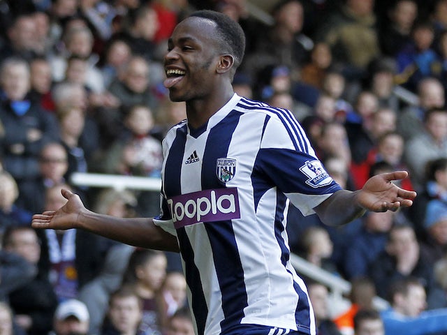 West Bromwich Albion's Burundian striker Saido Berahino cerebrates scoring their third goal during the English Premier League football match against West Ham United on December 28, 2013