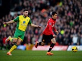 Shinji Kagawa of Manchester United is chased by Robert Snodgrass of Norwich City during the Barclays Premier League match on December 28, 2013