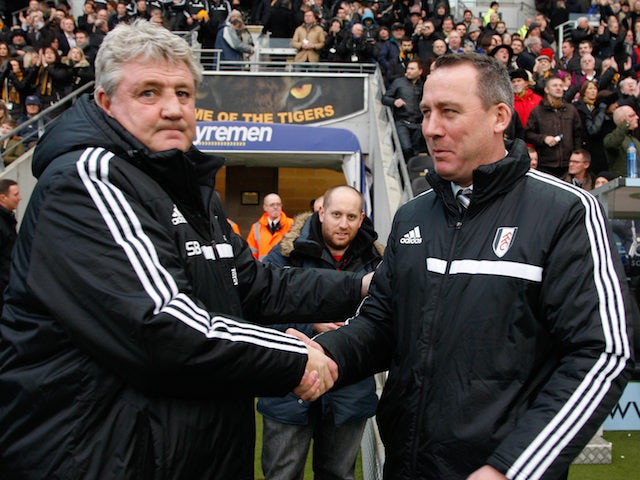 Steve Bruce manager of Hull City greets Rene Meulensteen manager of Fulham before the Barclays Premier League match between Hull City and Fulham at KC stadium on December 28, 2013