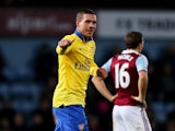 Lukas Podolski of Arsenal celebrates as he scores their third goal during the Barclays Premier League match between West Ham United and Arsenal at Boleyn Ground on December 26, 2013
