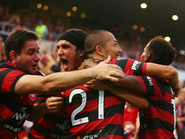 Jerome Polenz, Shinji Ono and Youssouf Hersi of the Wanderers celebrate the second goal to Youssouf Hersi during the round 11 A-League match between the Western Sydney Wanderers and the Central Coast Mariners at Parramatta Stadium on December 23, 2013