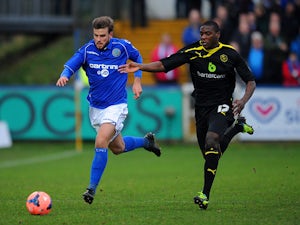 Macclesfield's Andy Halls and Sheffield Wednesday's Jeremy Helan in action during their FA Cup third round match on January 4, 2013