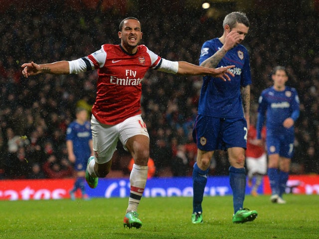 Arsenal's English midfielder Theo Walcott celebrates scoring their second goal during the English Premier League football match between Arsenal and Cardiff City at the Emirates Stadium in London on January 1, 2014