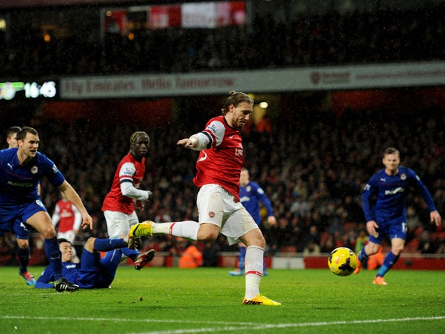 Nicklas Bendtner of Arsenal scores their first goal during the Barclays Premier League match between Arsenal and Cardiff City at Emirates Stadium on January 1, 2014