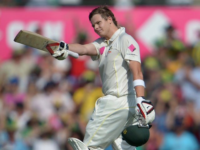 Australian batsman Steve Smith raises his bat after reaching his century on the first day of the fifth Ashes cricket Test against England at the Sydney Cricket Ground on January 3, 2014