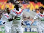 Lyon's French forward Bafetimbi Gomis (C) celebrates with teammates after scoring a goalduring a French Cup football match between La Suze-sur-Sarthe and Olympique Lyonnais on January 5, 2014