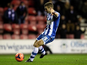 Wigan's Callum McManaman scores his team's third goal against MK Dons during their FA Cup third round match on January 4, 2013