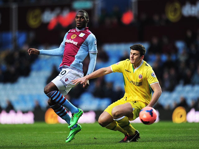 Aston Villa's Christian Benteke and Sheffield United's Harry Maguire in action during their FA Cup third round match on January 4, 2013