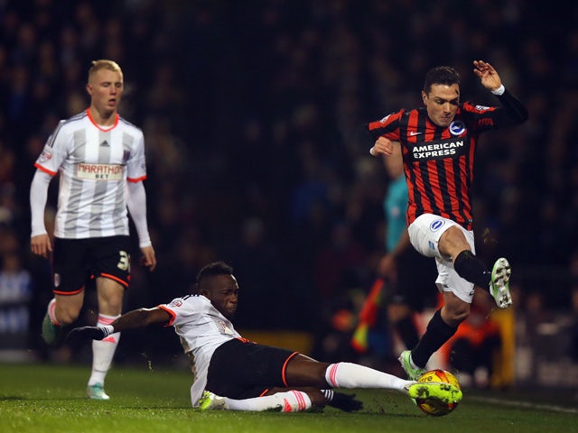 Adrian Collunga of Brighton & Hove Albion jumps over of Seko Fofana of Fulham during the Sky Bet Championship match between Fulham and Brighton & Hove Albion at Craven Cottage on December 29, 2014