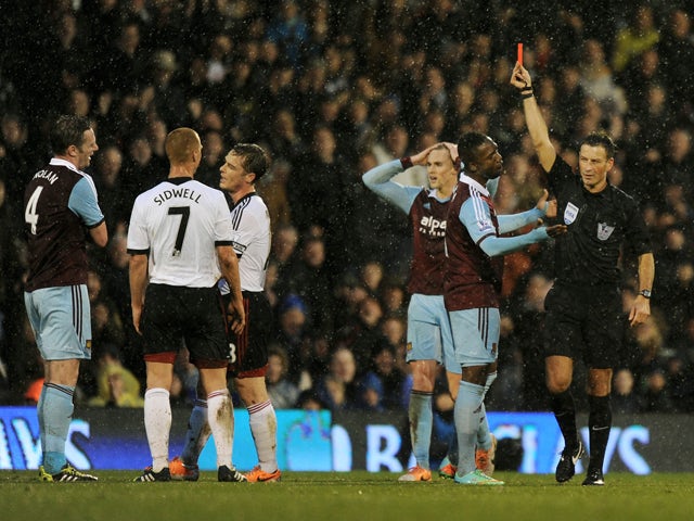 Kevin Nolan of West Ham is shown the red card by Referee Mark Clattenburg during the Barclays Premier League match between Fulham and West Ham United at Craven Cottage on January 1, 2014