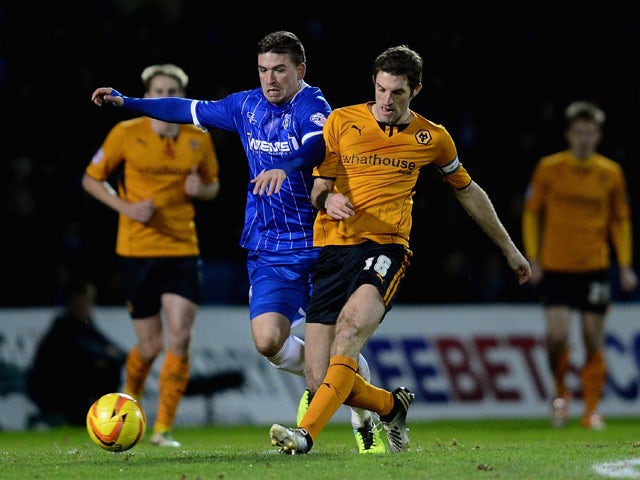 Cody McDonald of Gillingham battles with Sam Ricketts of Wolves during the Sky Bet League One match between Gillingham and Wolverhampton Wanderers at Priestfield Stadium on January 3, 2014 
