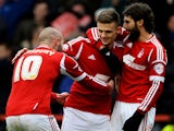 Jamie Paterson of Nottingham Forest (C) celebrates with Djamel Abdoun (R) and Henri Lansbury as he scores their second goal during the FA Cup game on January 5, 2014
